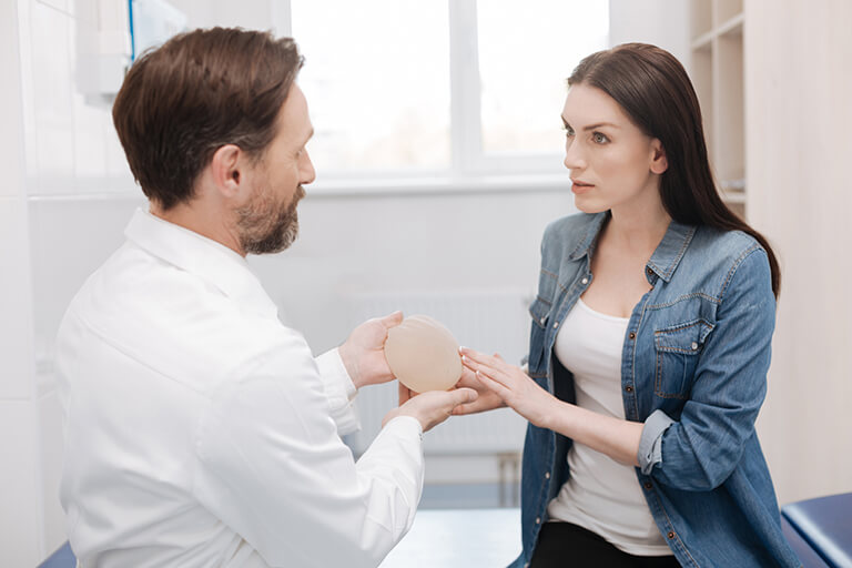 Doctor showing an implant to a woman